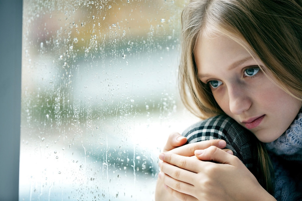 Rainy Day: sad Girl on the Window - Фото, зображення
