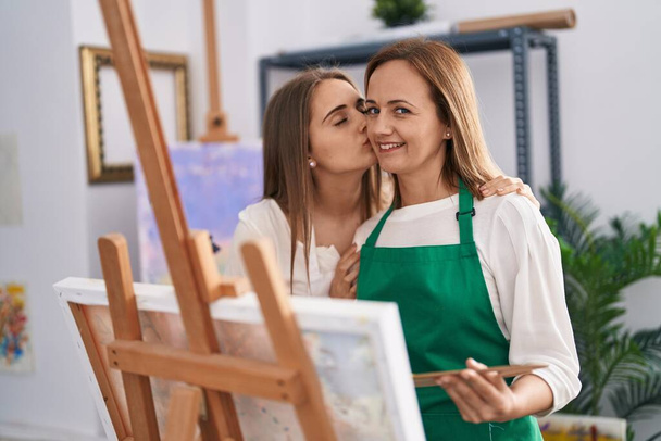 Dos mujeres artistas dibujando y besándose en el estudio de arte - Foto, imagen