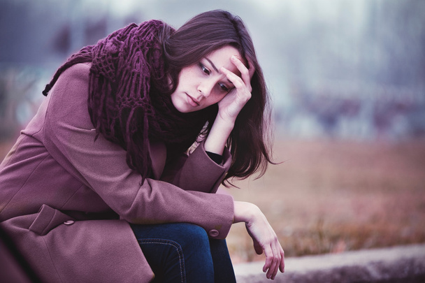 Sad Young Woman Sitting Outdoors - Photo, Image