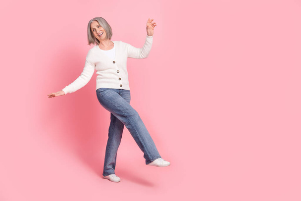 Full size portrait of carefree overjoyed aged lady enjoy dancing have good mood empty space isolated on pink color background. - Foto, Bild
