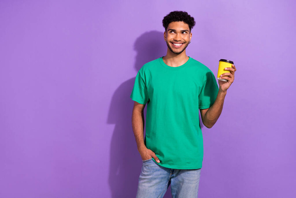 Photo of funny attractive young guy hold paper eco cup coffee drink latte americano cappuccino isolated purple color background. - Foto, immagini