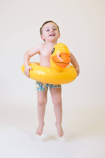 adorable boy with a float on a white background. Summer Vacation.. - Photo, Image