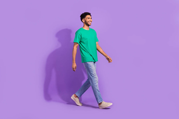 Full body photo of young man steps satisfied stylish casual clothes shopping offer purchase cheap look isolated on violet color background. - Valokuva, kuva