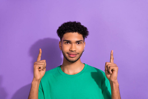 Photo of funny cool nice youngster guy direct fingers up empty space wear green shirt isolated purple pastel color background. - Fotografie, Obrázek