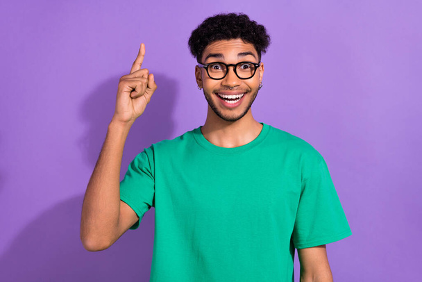 Photo of clever intelligent man wear green t-shirt spectacles pointing finger up isolated purple color background. - Fotografie, Obrázek