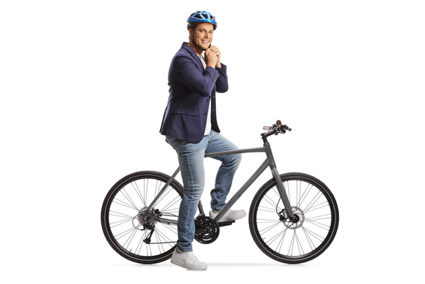 Man with a bicycle putting on a helmet isolated on white background - Foto, afbeelding