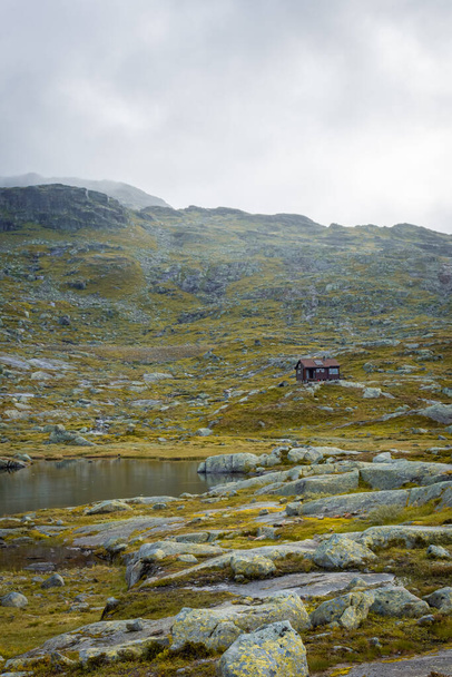 Wooden hut in the Norwegian mountains, moody landscape in the trail for Trolltunga - 写真・画像