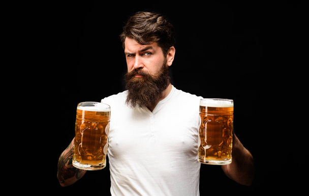 Beer time. Bearded man with lager beer mugs at bar or pub. Stylish guy with craft beer. Tasting fresh brewed ale. Oktoberfest festival. Beer degustation. Drink, alcohol, leisure and people concept - Fotoğraf, Görsel