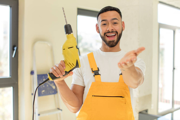 arab handsome man arab man smiling happily and offering or showing a concept. handyman concept - Photo, image