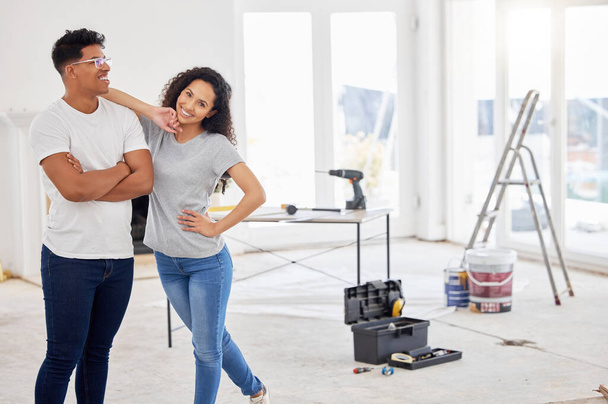 Maintenance, renovation and portrait with a couple in their new home together for a remodeling project. Construction, real estate or diy property improvement with a man and woman bonding in a house. - Photo, image