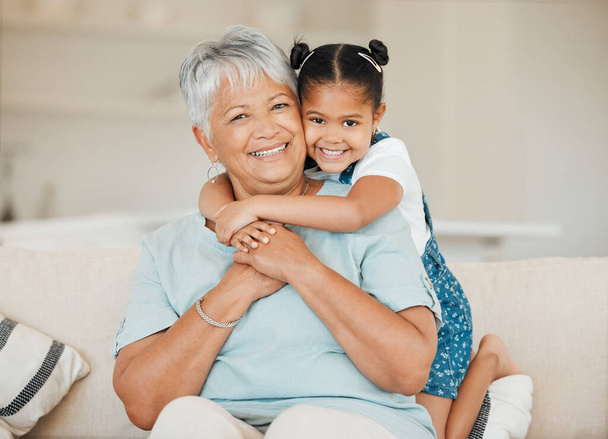 Family, grandmother and grandchild hug with smile in portrait, happiness and bonding at home. Love, care and trust with elderly woman and young child in living room, embrace and happy at house. - Foto, Imagen