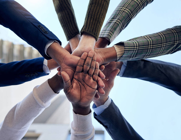 Group, hands and together in circle for celebration, collaboration or people in business, company and teamwork. Businesspeople, below and celebrate success, deal or outdoor workplace team building. - Fotografie, Obrázek