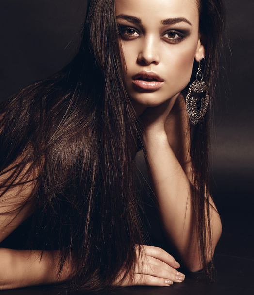     fashion studio photo of beautiful sensual woman with dark hair wearing elegant dress and bijou           - Foto, Bild