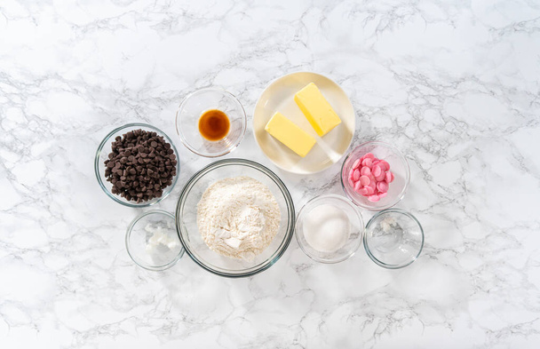 Flat lay. Measured ingredients in glass mixing bowls to bake panda-shaped shortbread cookies with chocolate icing. - Fotografie, Obrázek