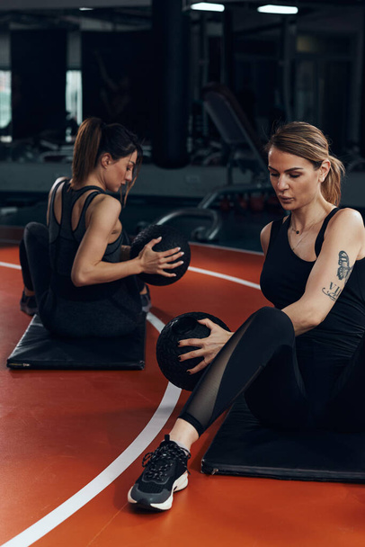 Pretty women working out in a gym with a ball. - Photo, Image