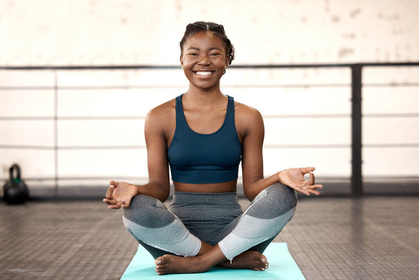 Happy black woman, yoga and meditation in gym for spiritual wellness, zen or calm fitness workout. Portrait of African female person or yogi with smile for healthy mind, body and meditating exercise. - Fotoğraf, Görsel