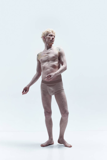 Portrait with antique man with blond hair wearing underwear posing shirtless like sculpture isolated over white studio background. Concept of male body aesthetics, mens beauty, inspiration, art, ad - Foto, Imagen