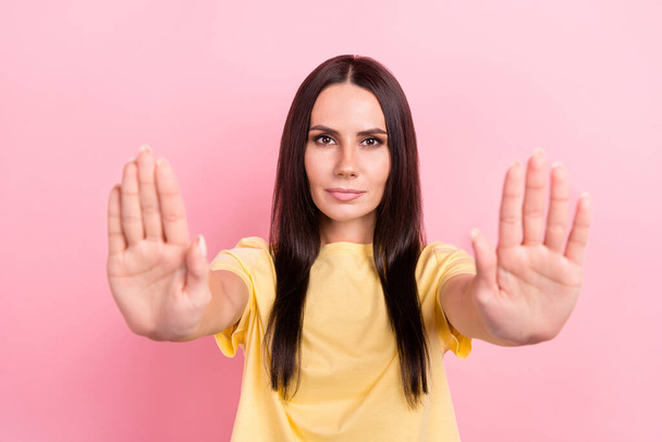 Photo of confident serious woman dressed yellow t-shirt rising arms palms saying no isolated pink color background. - Fotoğraf, Görsel