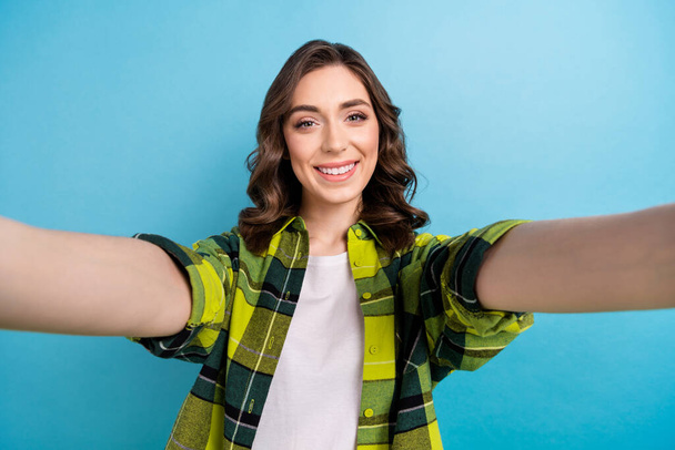 Photo of pretty adorable lady wear checkered jacket smiling recording video vlog isolated blue color background. - Fotoğraf, Görsel