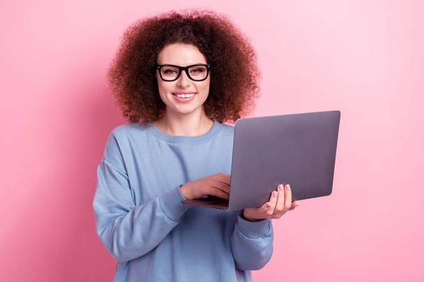 Photo of cheerful specialist author copywriter young girl hold new dell netbook use internet sources isolated on pink color background. - Фото, зображення