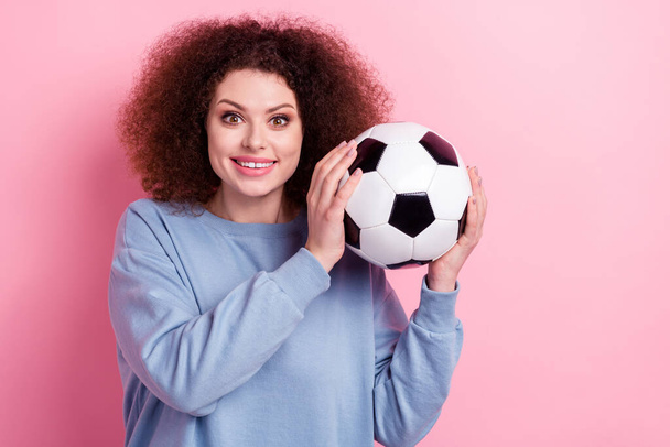 Photo of positive good mood lady dressed blue pullover rising football ball smiling isolated pink color background. - Fotoğraf, Görsel