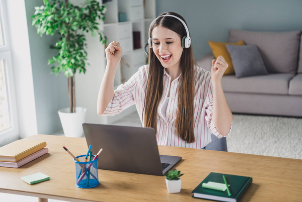 Photo portrait of attractive young woman amazed raise fists call center dressed stylish smart casual clothes interior cozy room home office. - Φωτογραφία, εικόνα