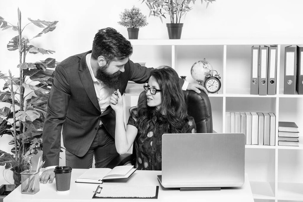 Full of flirt. Flirty woman touch man by beard. Flirting at work. Businesswoman flirting with businessman at desk. Office romance. Workplace relationship. - Photo, Image