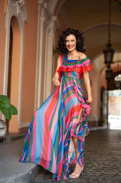 beautiful woman in colorful dress walking in the city.  - Fotó, kép