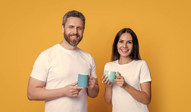 Morning drink of family couple. Good morning. Couple of guy and girl drinking morning coffee. Happy couple enjoying coffee in morning studio. - Фото, изображение
