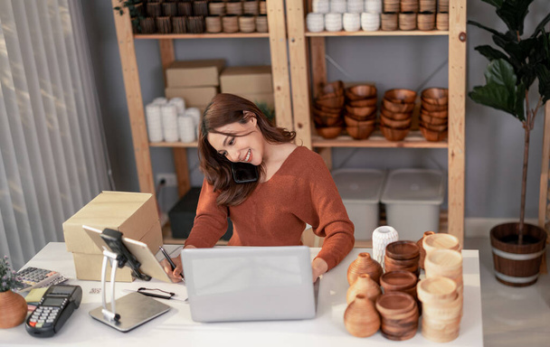 Vase brand owner processes online orders. Response to customer queries and concerns about products and shipment to increase long term loyalty and satisfaction. Routine work of e commerce entrepreneur - 写真・画像