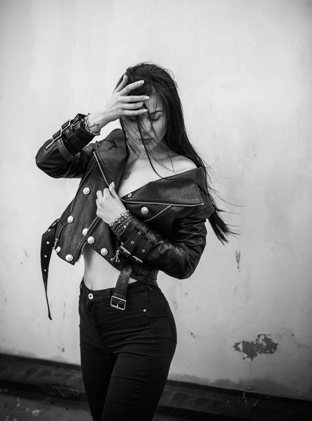 Grunge style, Beautiful sexy young woman with a dark long hair in leather jacket. Style of 90s - Фото, изображение