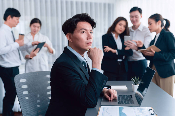 Portrait of focus young successful confident male manager, executive wearing business wear in harmony office arm crossed with blurred meeting background of colleagues, office worker. - 写真・画像