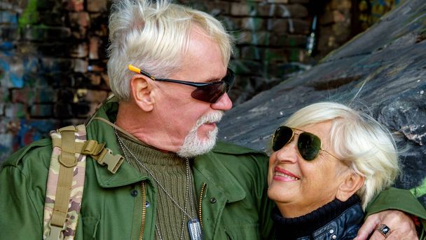 Cute couple elderly man and woman in fashionable tourist clothing for outdoor activities - Photo, Image