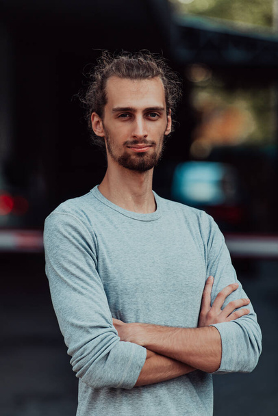 Portrait of a young successful businessman with crossed arms in front of the company. High quality photo - Fotoğraf, Görsel