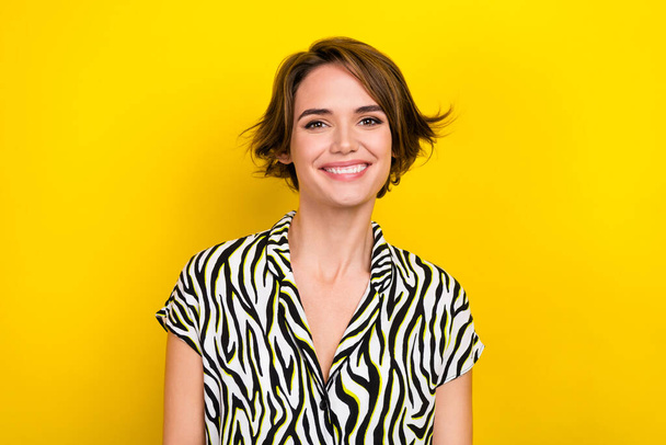 Photo portrait of charming girl beaming white teeth smile wear zebra striped summer blouse isolated yellow color background. - Foto, Imagen