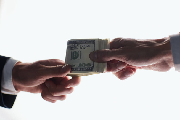 Man offering batch of hundred dollar bills. Hands close up. - Fotó, kép