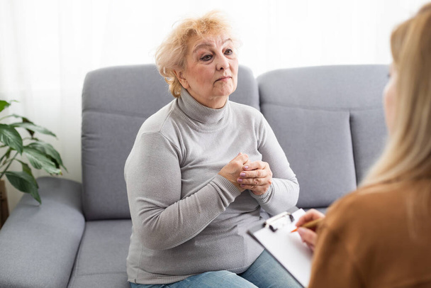 Depressed senior woman talking with female psychologist. - Fotografie, Obrázek