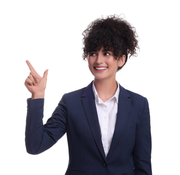 Beautiful businesswoman in suit pointing at something on white background - Foto, afbeelding