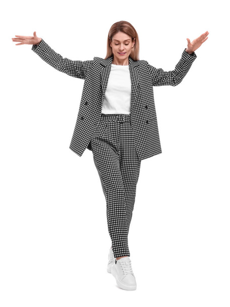 Beautiful businesswoman in suit walking on white background - Photo, image
