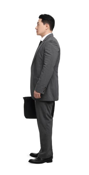 Businessman with briefcase posing on white background - Fotoğraf, Görsel