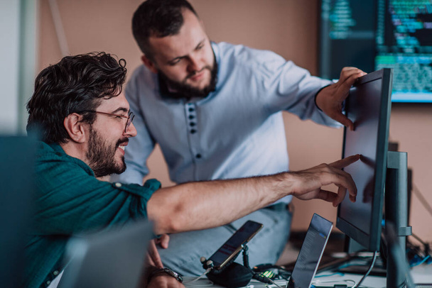 Programmers engrossed in deep collaboration, diligently working together to solve complex problems and develop innovative mobile applications with seamless functionality - 写真・画像
