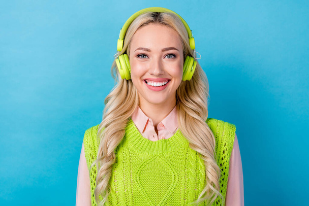 Photo of lovely cheerful girl beaming smile enjoy listen music headphones isolated on blue color background. - Foto, Bild