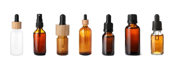 Set of different cosmetic oils in bottles on white background - 写真・画像