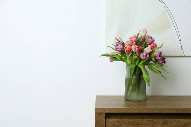 Beautiful bouquet of colorful tulip flowers on wooden table indoors. Space for text - Fotó, kép