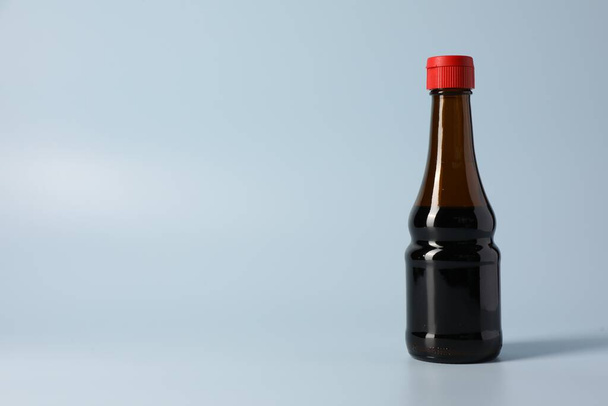 Bottle with soy sauce on light grey background, space for text - Foto, Imagem