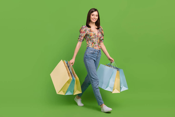 Full length photo of young girl shopping lover advert new bershka collection clothes walk with bargains isolated on green color background. - Foto, Bild