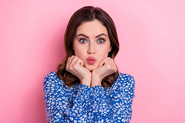 Portrait of pleasant adorable girl with curly hairstyle wear blue dress hands on cheeks pouted lips isolated on pink color background. - Foto, Imagen