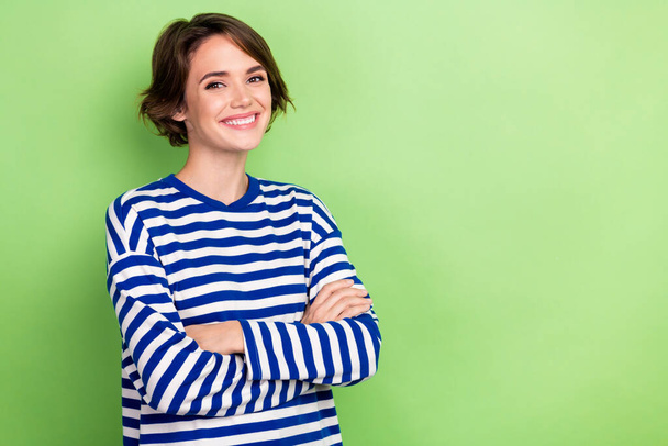 Photo of young office worker lady hold arms crossed professional agent hr wear blue striped shirt isolated green color background. - 写真・画像