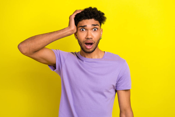 Portrait of impressed confused person arm touch head open mouth speechless staring isolated on yellow color background. - Foto, immagini