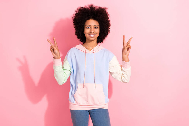 Photo of funky cheerful girl toothy smile hands fingers demonstrate v-sign have good mood isolated on pink color background. - Foto, immagini
